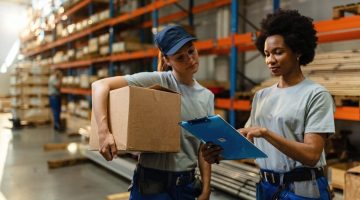 african-american-worker-her-coworker-reading-order-list-before-shipment-while-working-warehouse_637285-3978