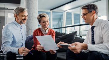 happy-couple-financial-advisor-going-through-plans-meeting_637285-11088
