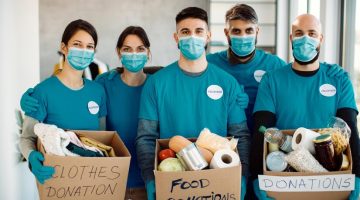 team-volunteers-holding-donation-boxes-looking-camera_637285-10775